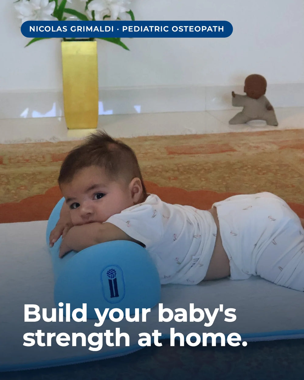 Baby in supported tummy time on The Core pillow, looking toward camera