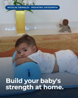 Baby in supported tummy time on The Core pillow, looking toward camera